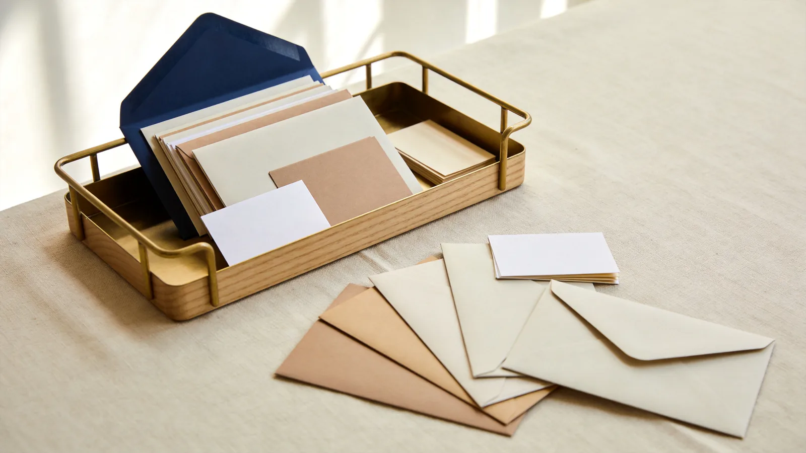 Envelopes and note cards of every kind arriving from different directions and stacking into one desk in-tray